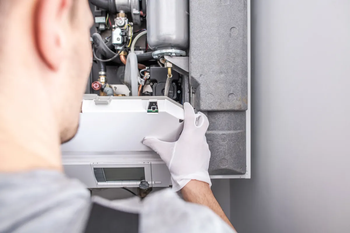 Heating engineer servicing a boiler