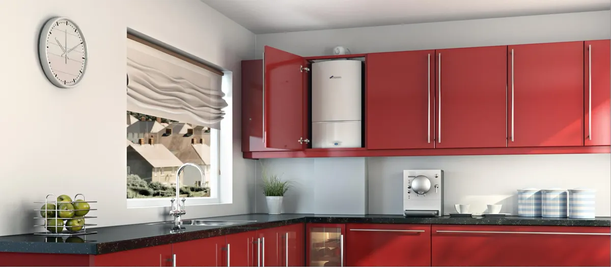 White boiler installed inside a red kitchen wall cabinet